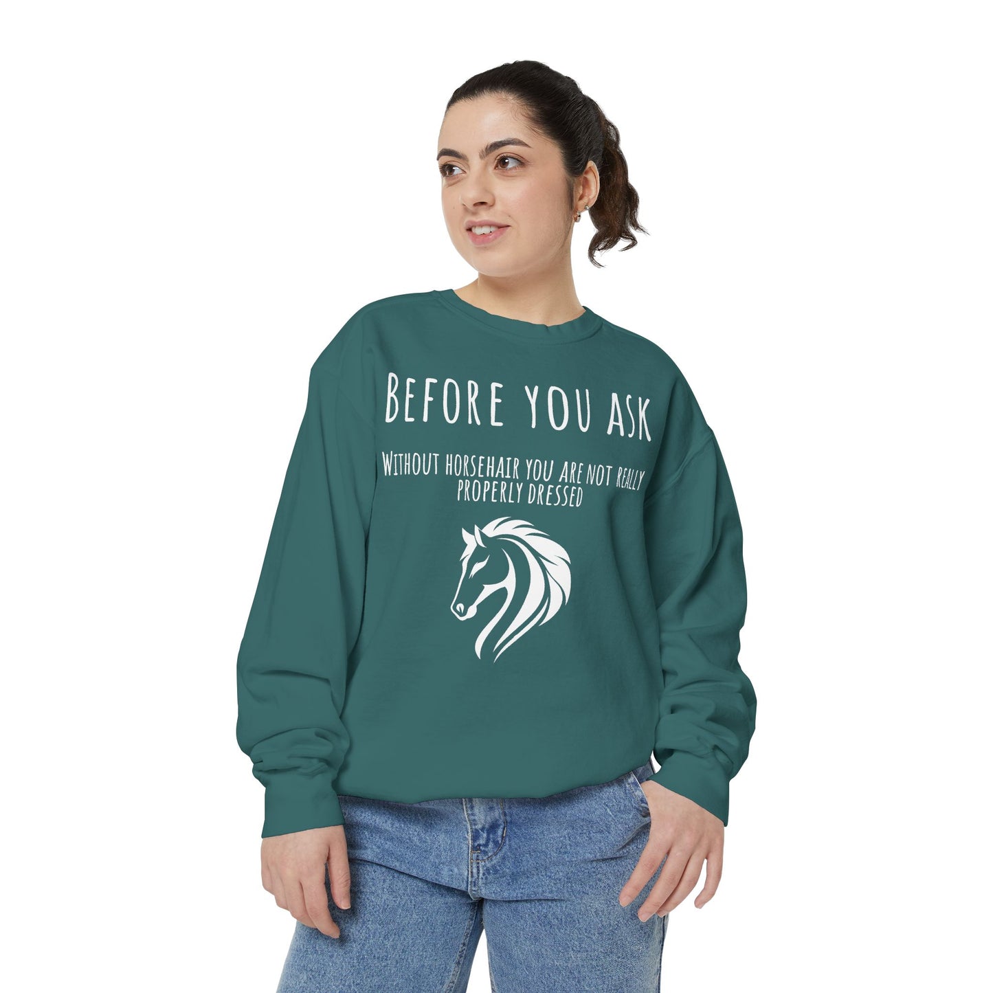 Person wearing a teal sweatshirt with horse-related text and graphic on a white background
