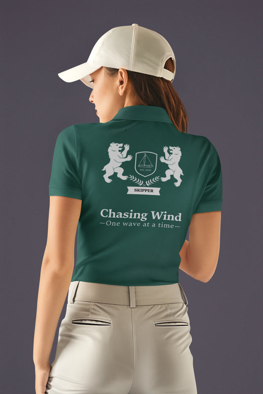 Sailing Polo Shirt Person wearing a green polo shirt with a logo and text on the back, against a dark background