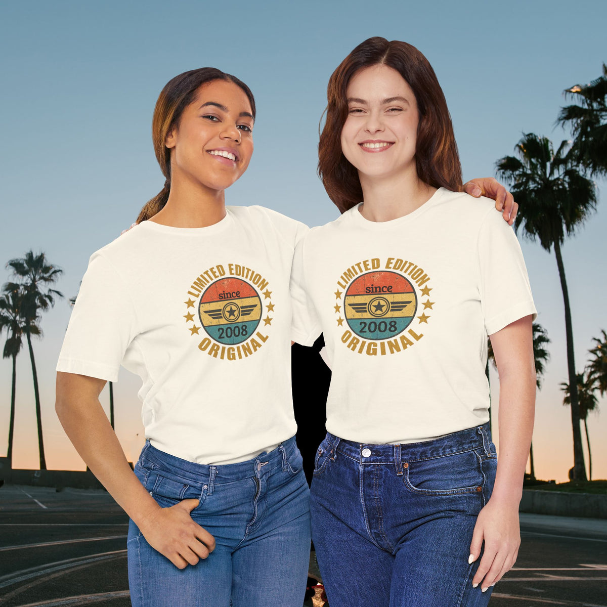 custom year birthday t shirt Two women standing outdoors at sunset wearing matching white graphic T-shirts with a retro circular design that reads 'LIMITED EDITION since 2008 ORIGINAL' and 'FUEL' in the center, paired with blue jeans.