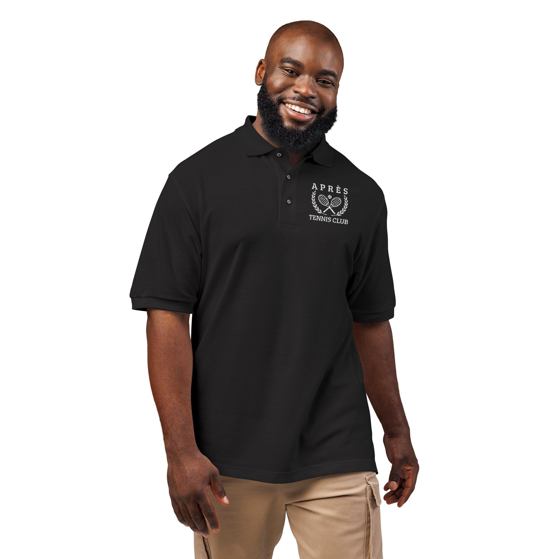 Tennis Polos Man wearing a black polo shirt with a logo on a white background