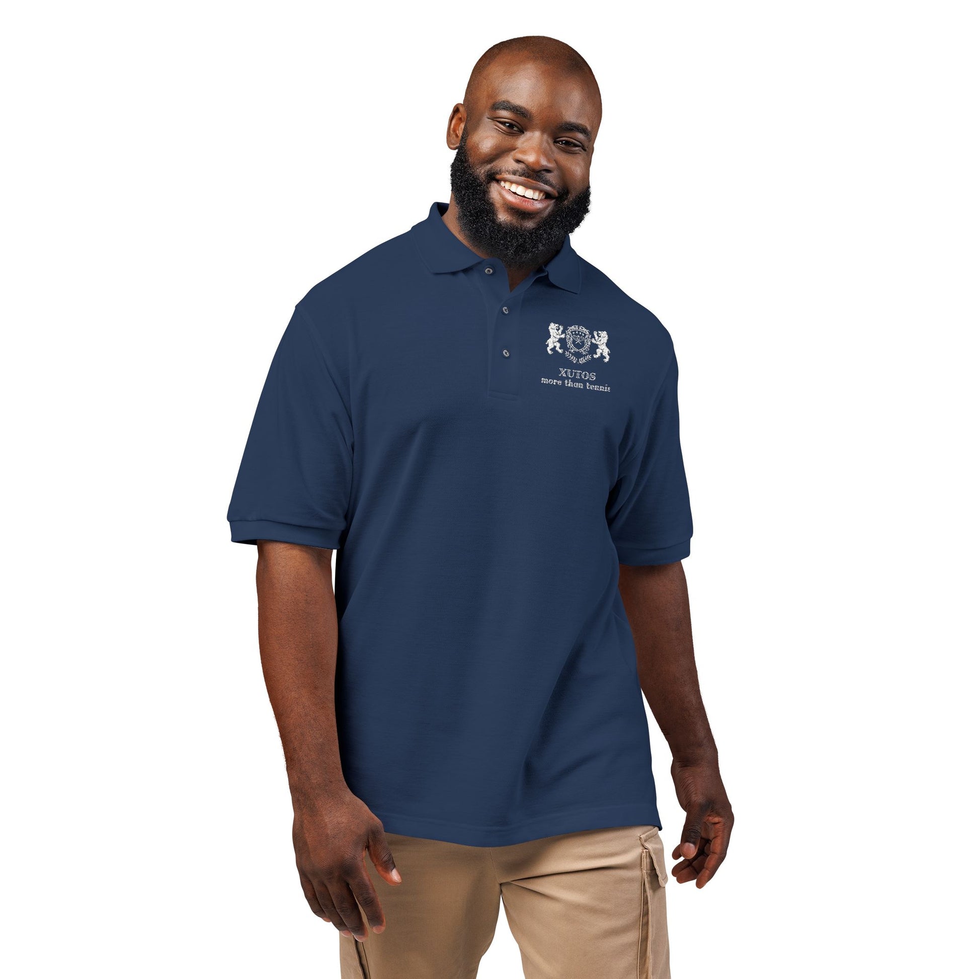 Man wearing a navy blue polo shirt with a logo on a white background