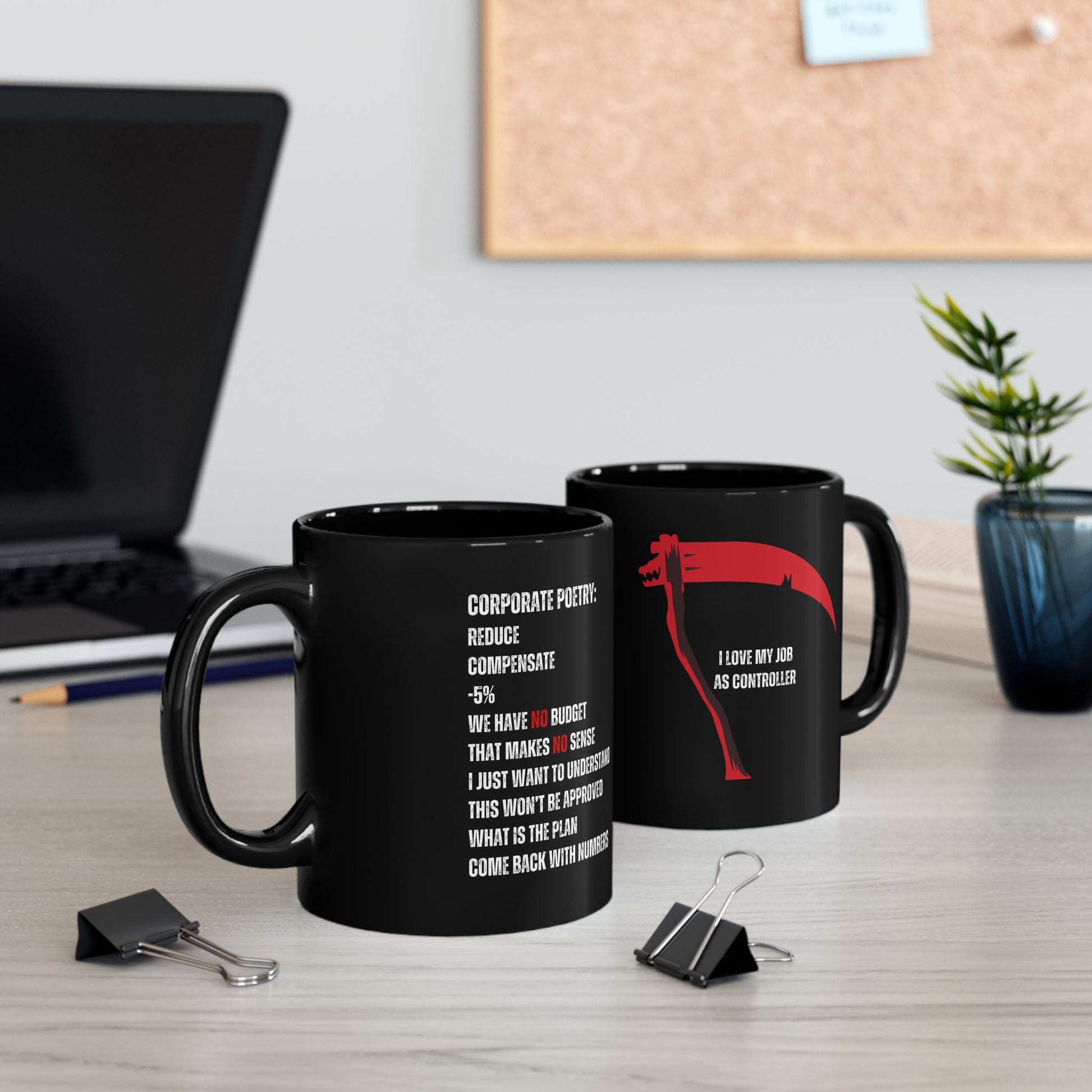 Two black mugs on a desk with office items and a plant in the background