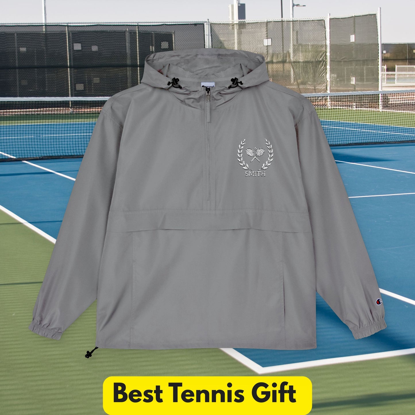 Tennis jacket Gray hooded jacket with a logo on a tennis court, labeled 'Best Tennis Gift'.