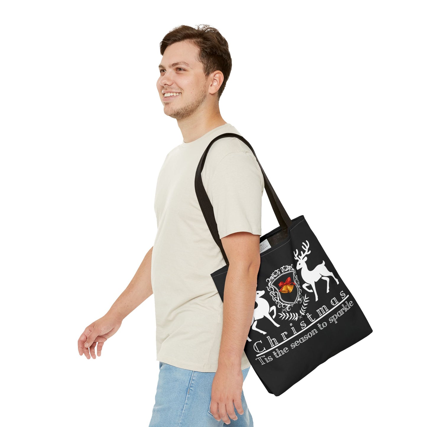 Man carrying a black tote bag with Christmas design on a white background