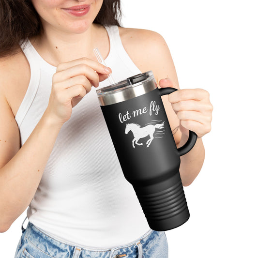 Person holding a black travel mug with 'let me fly' and horse design on a white background