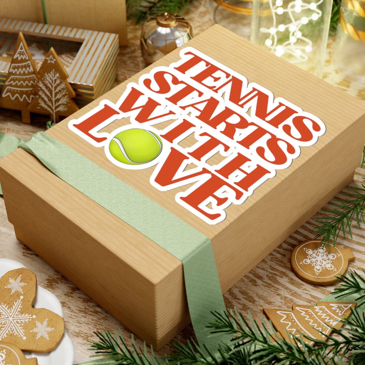 Wooden box with 'Tennis Starts With Love' text and a tennis ball graphic, surrounded by festive decorations.