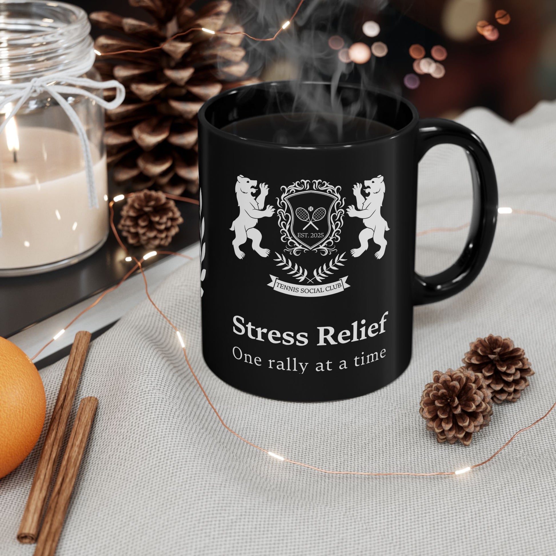 Tennis Mug Black mug with 'Stress Relief' text and design, surrounded by decorative items on a table.