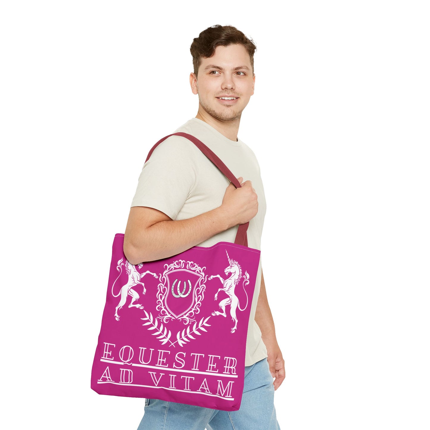 Man holding a pink tote bag with white designs and text on a white background