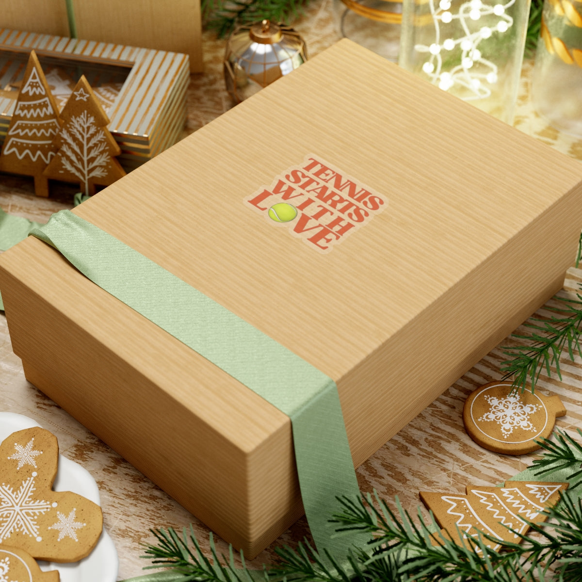 Gift box with 'Tennis with Love' text on a festive background with cookies and decorations