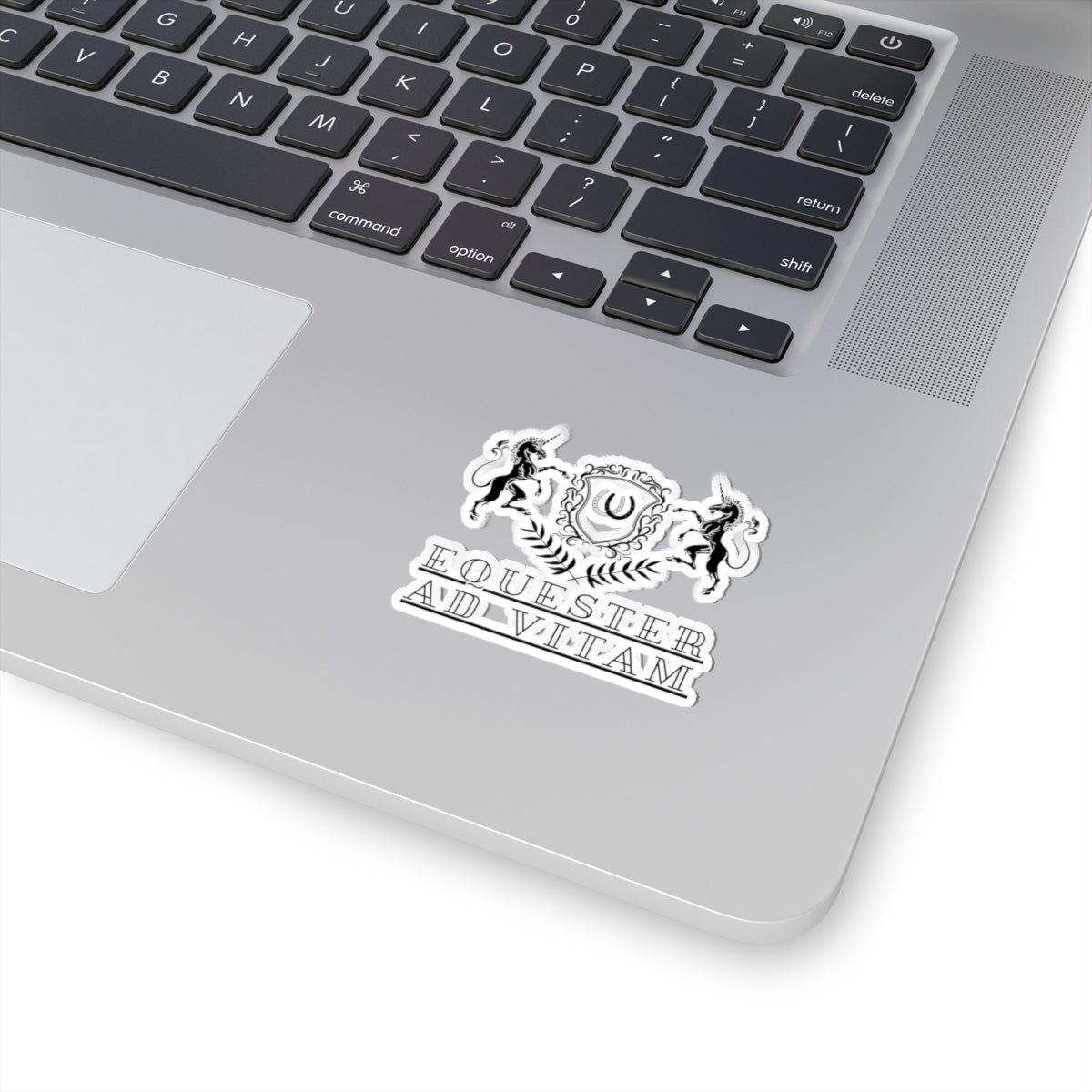 Laptop with a sticker featuring a horse and text on the palm rest area.