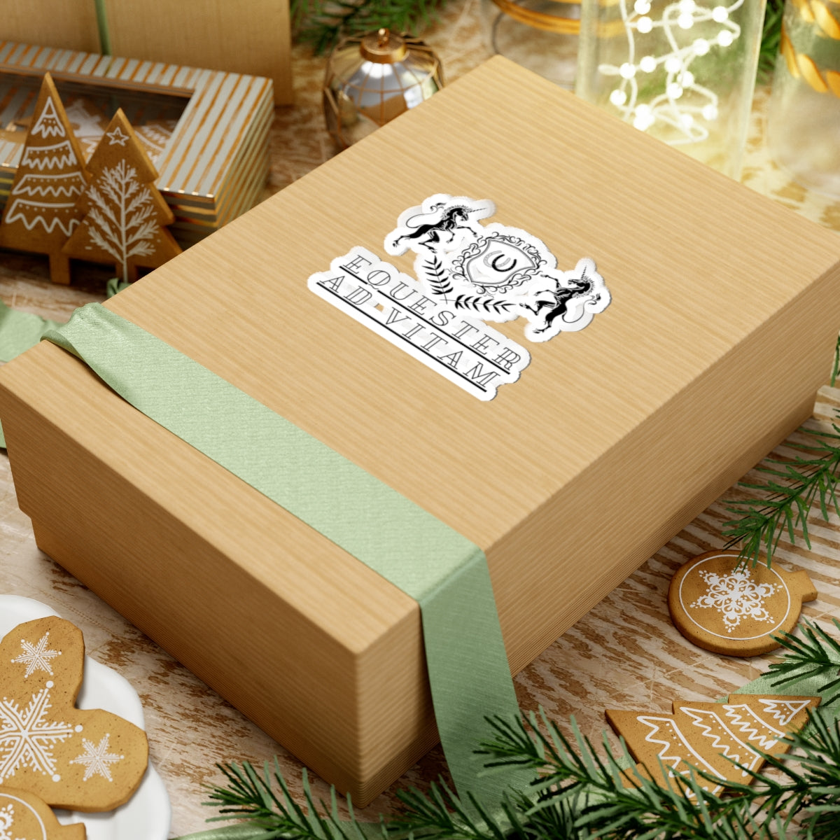 Wooden gift box with a green ribbon and decorative label on a festive background with cookies and lights.