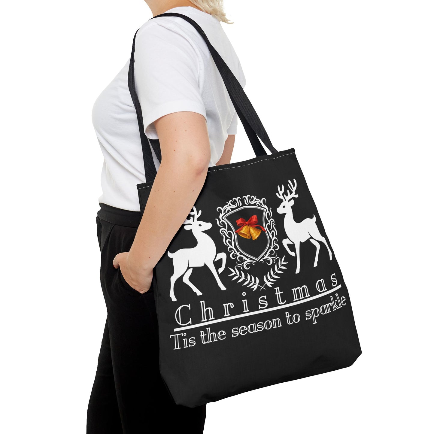 Black tote bag with Christmas design held by a person on a white background