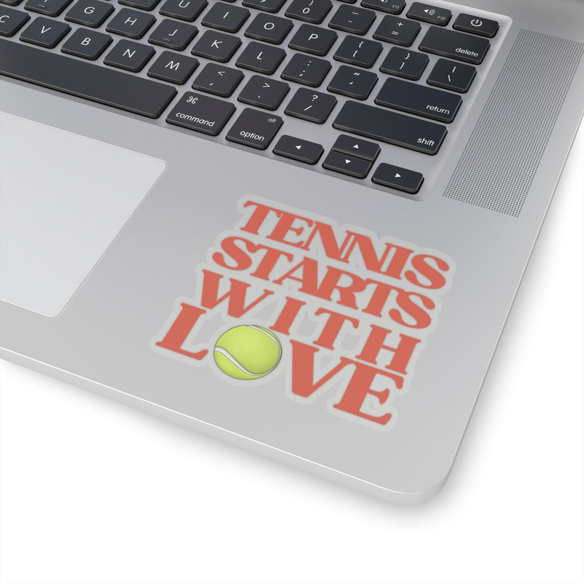 Laptop with a 'Tennis Starts with Love' sticker on the palm rest area