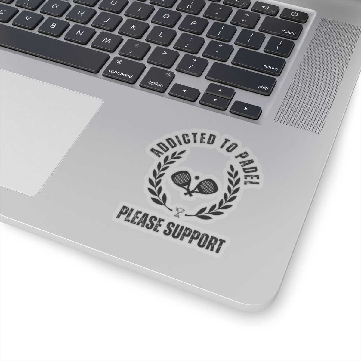 Laptop with a sticker that reads 'Addicted to Padel Please Support' on a white background