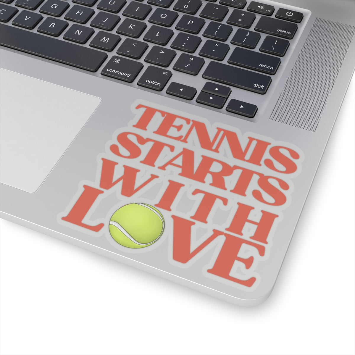 Laptop with a decal that says 'Tennis Starts with Love' on the trackpad.