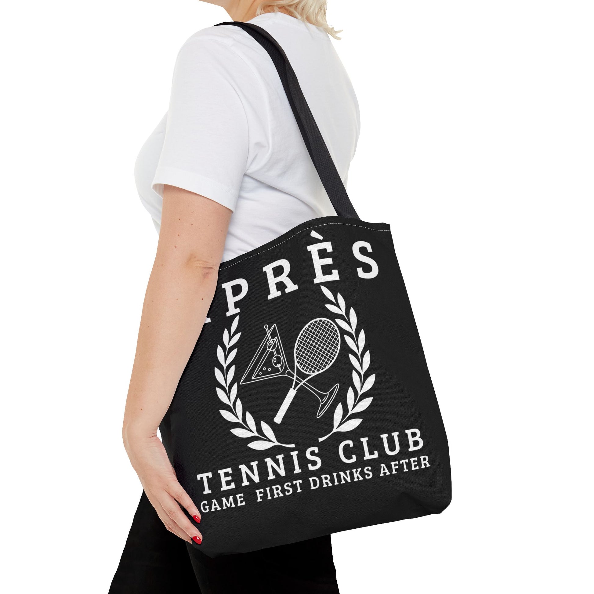 tennis tote bag Person holding a black tote bag with tennis club design and text.