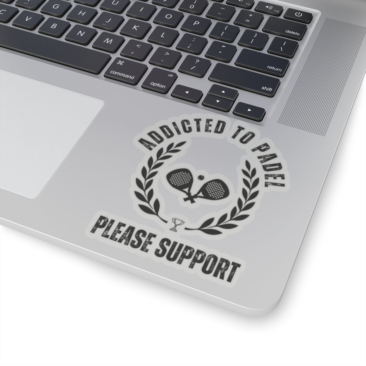 Laptop with a decal that reads 'Addicted to Padel Please Support' on the palm rest area.
