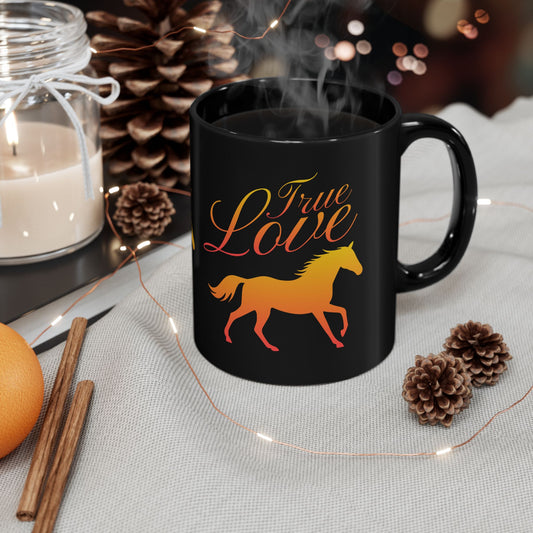 Black mug with 'True Love' and horse design, surrounded by decorative items on a table.