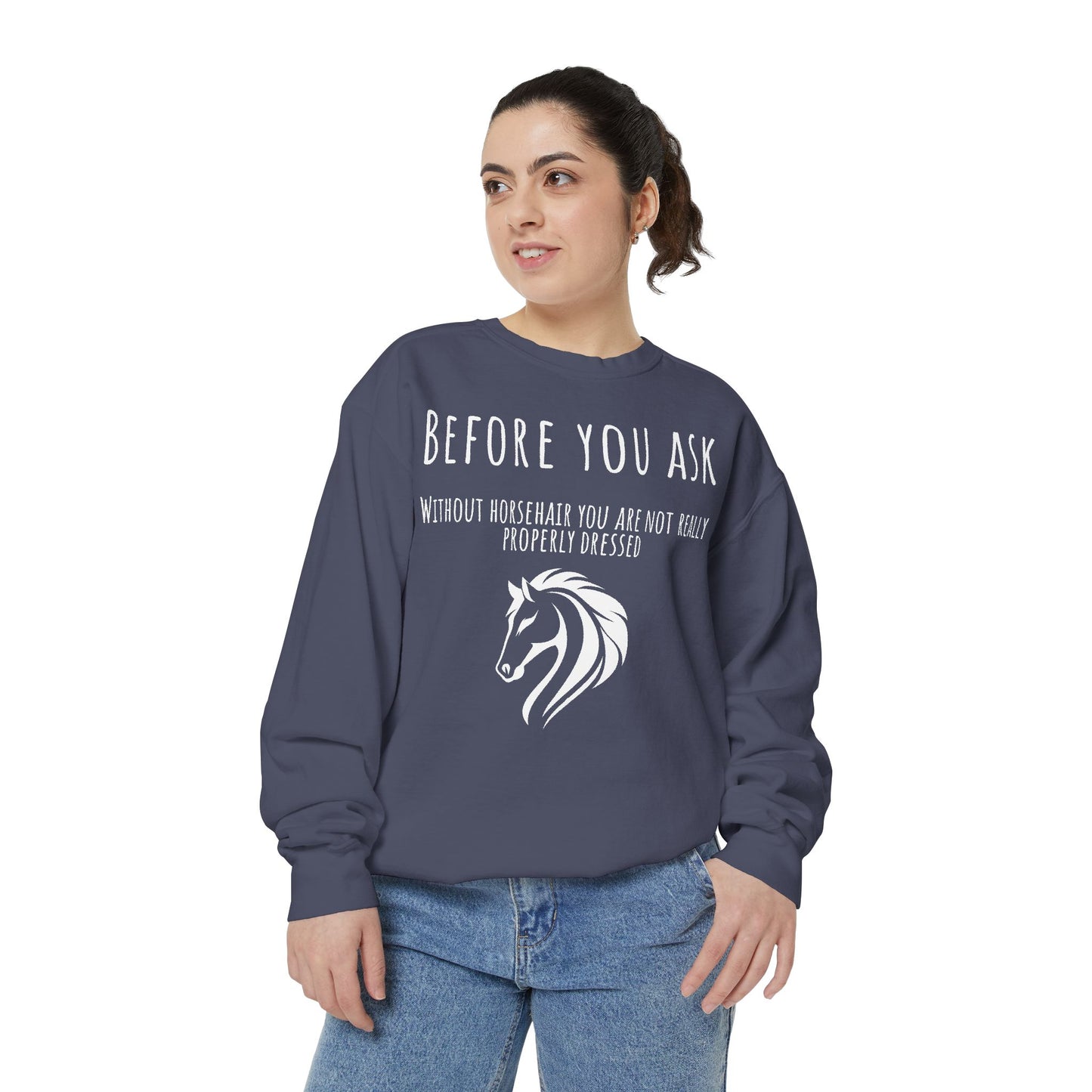 Person wearing a navy sweatshirt with a horse graphic and text on a white background