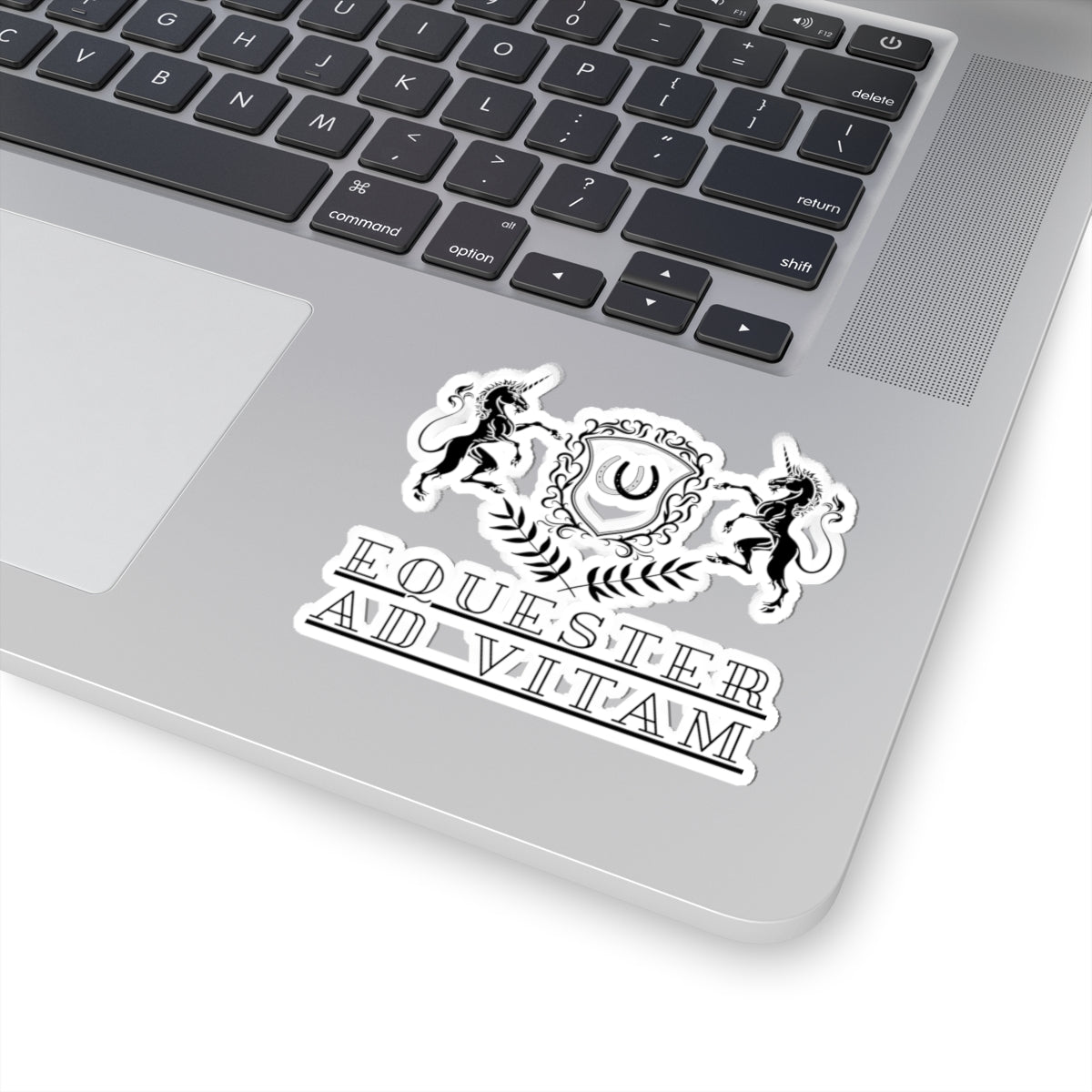 Laptop with a sticker on the palm rest area featuring a design and text.