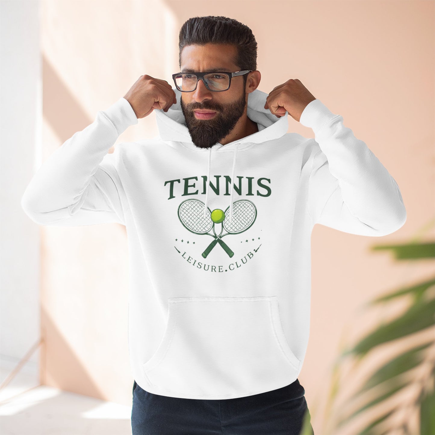Man wearing a white hoodie with text, flexing his muscles against a neutral background