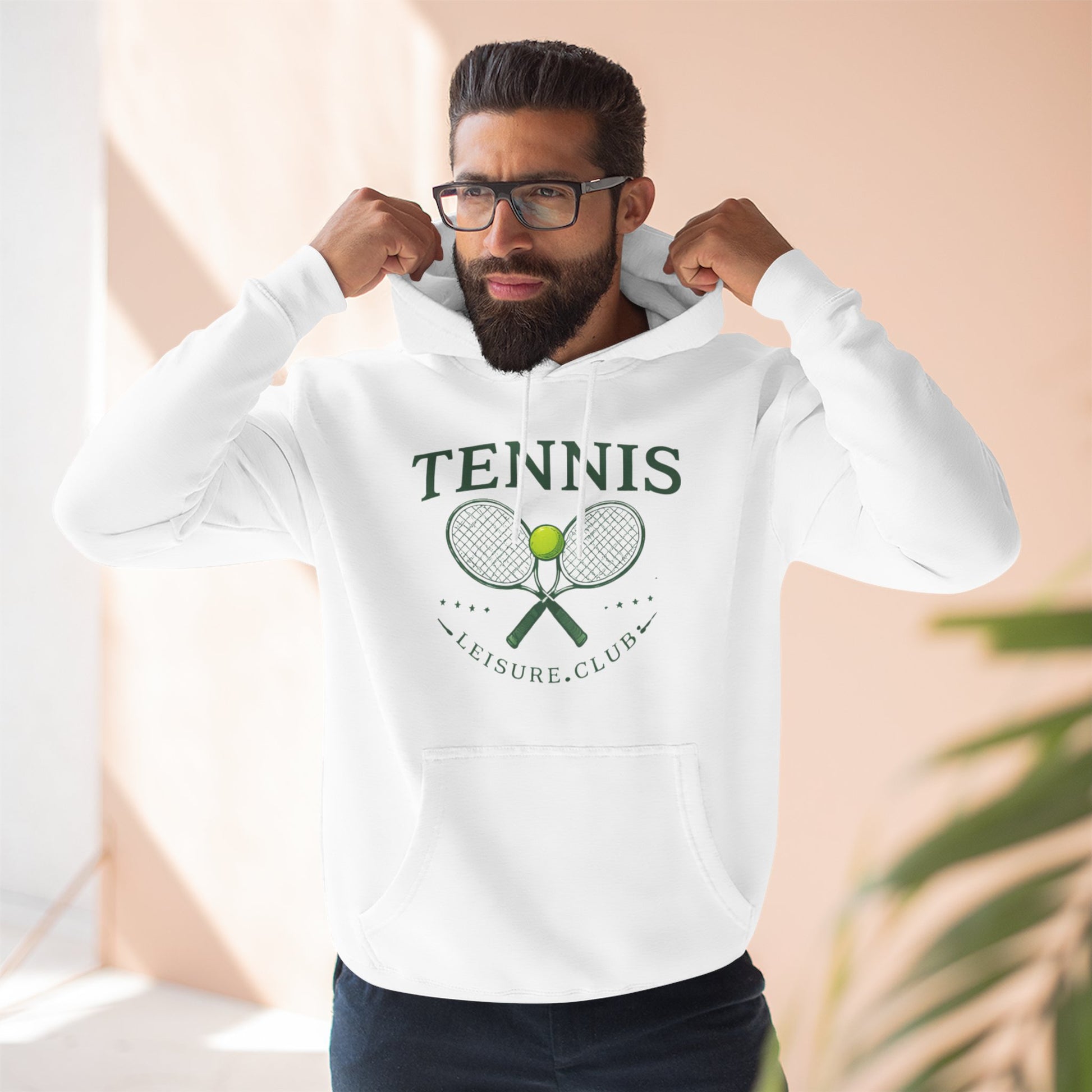 Man wearing a white hoodie with text, flexing his muscles against a neutral background