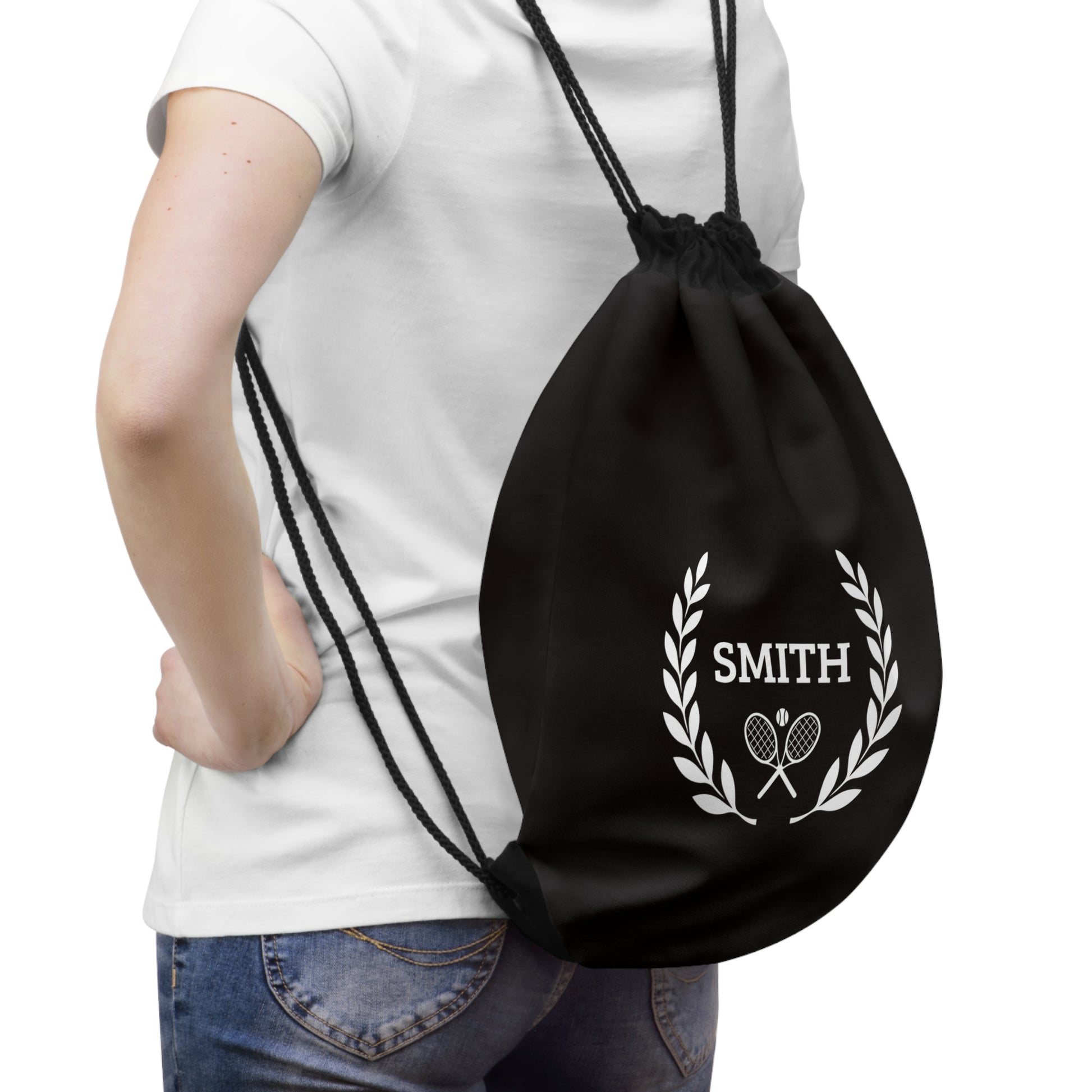 Junior Tennis bag Black drawstring bag with 'SMITH' and laurel wreath design held by a person wearing a white t-shirt.