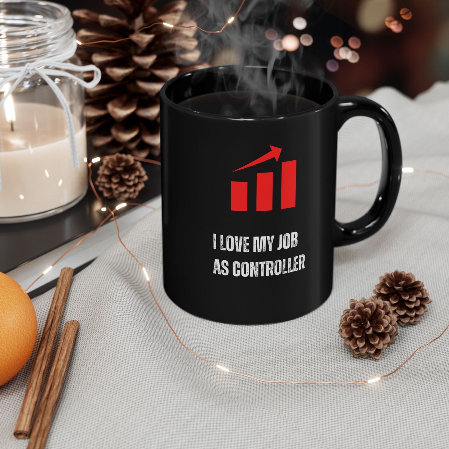 Office Controller Mug Black mug with a red logo and text, surrounded by decorative items on a table.