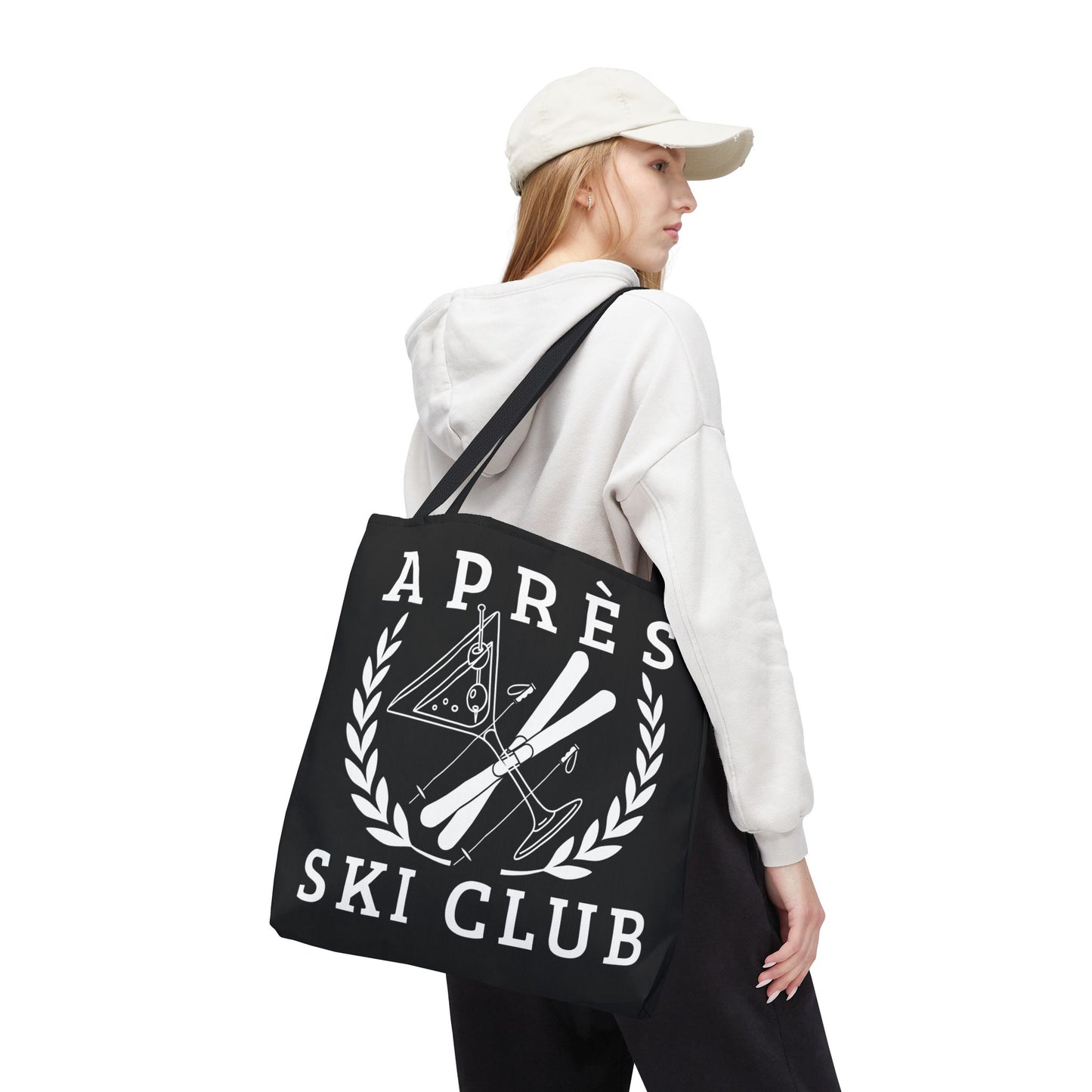 ski tote bag Person wearing a black tote bag with 'Apres Ski Club' design on a white background