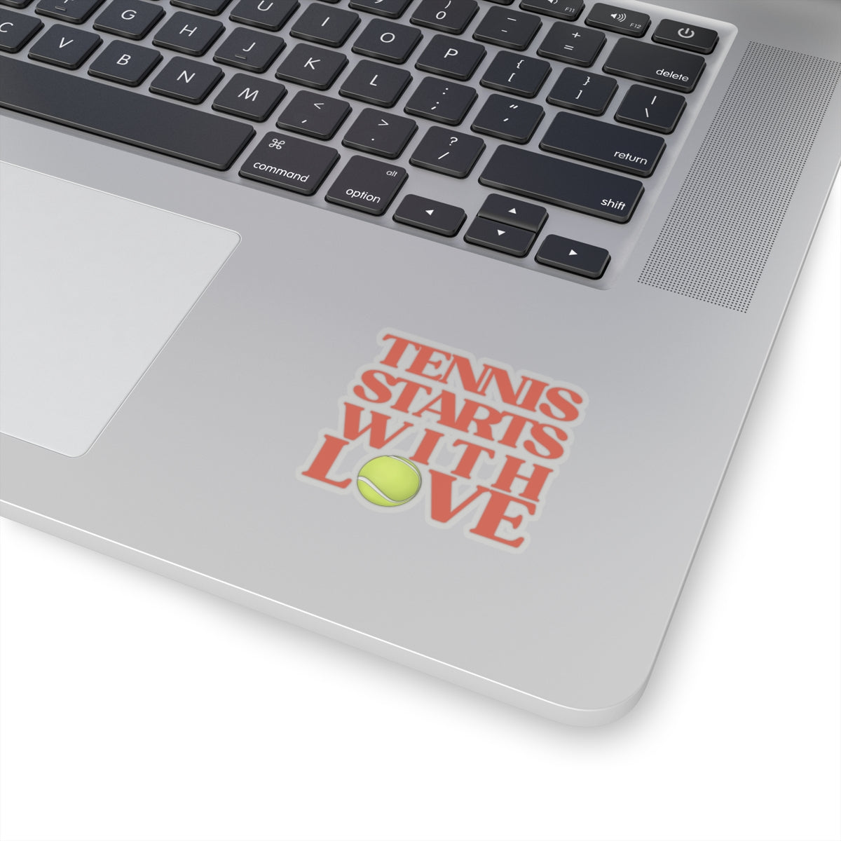 Laptop with a 'Tennis Starts with Love' sticker on the palm rest area