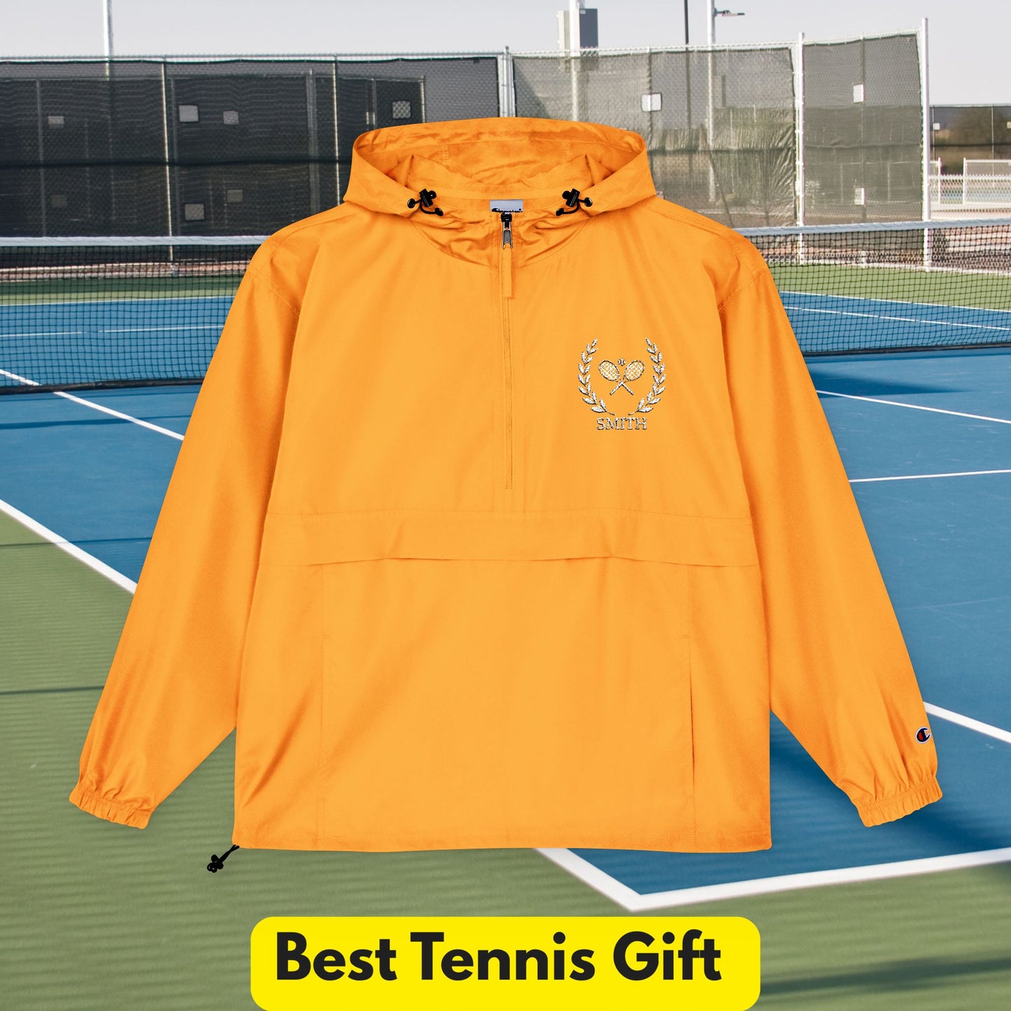 Tennis jacket Orange hooded jacket with a logo on a tennis court, labeled 'Best Tennis Gift'.