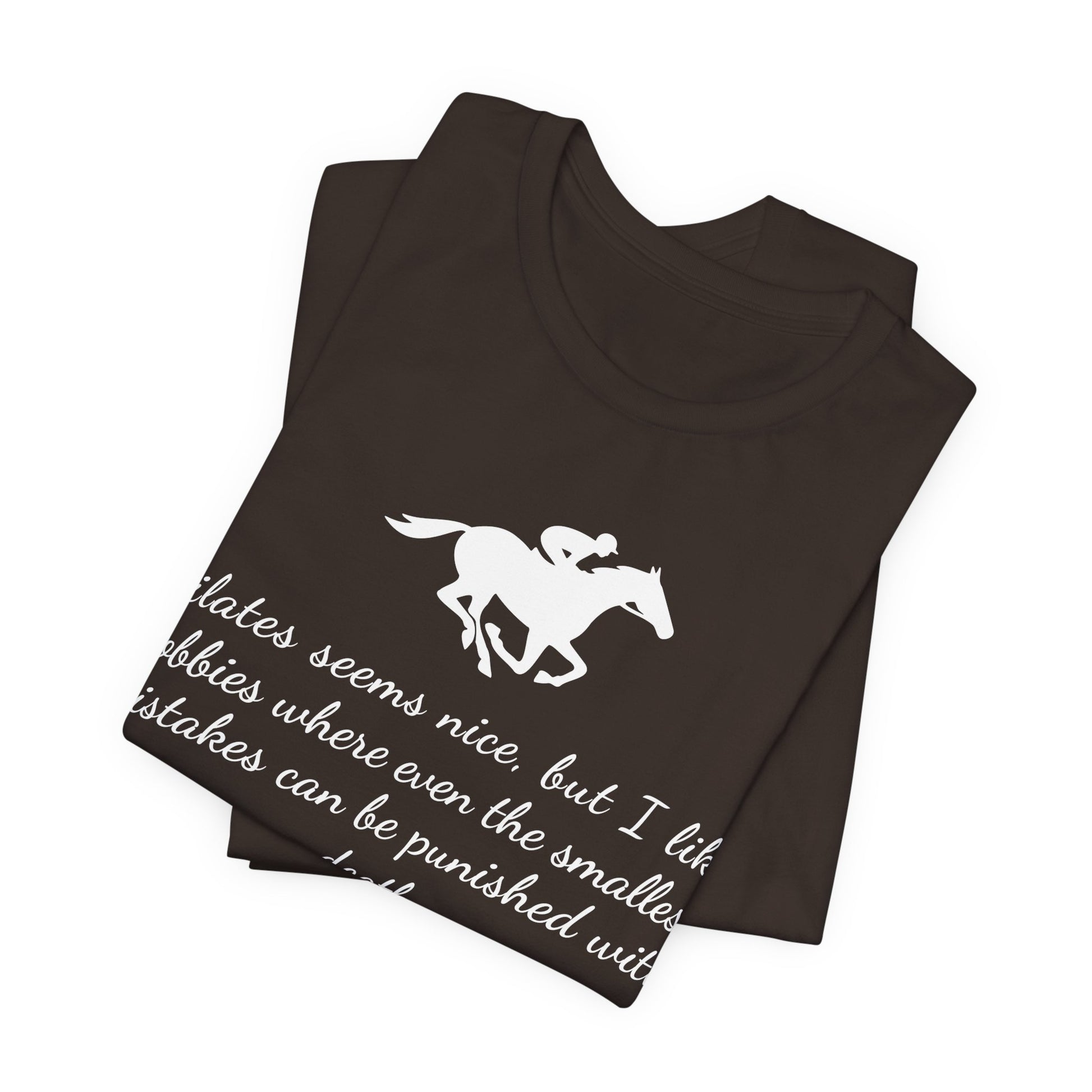 Folded black t-shirt with white horse and text design on a white background