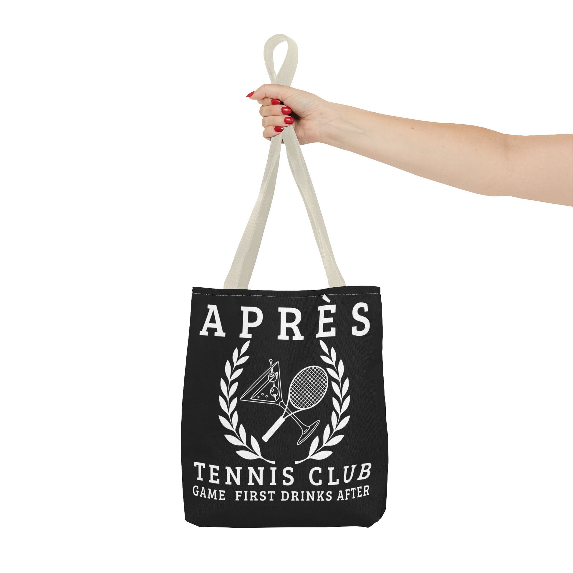 tennis tote bag Black tote bag with tennis-themed design held by a hand on a white background