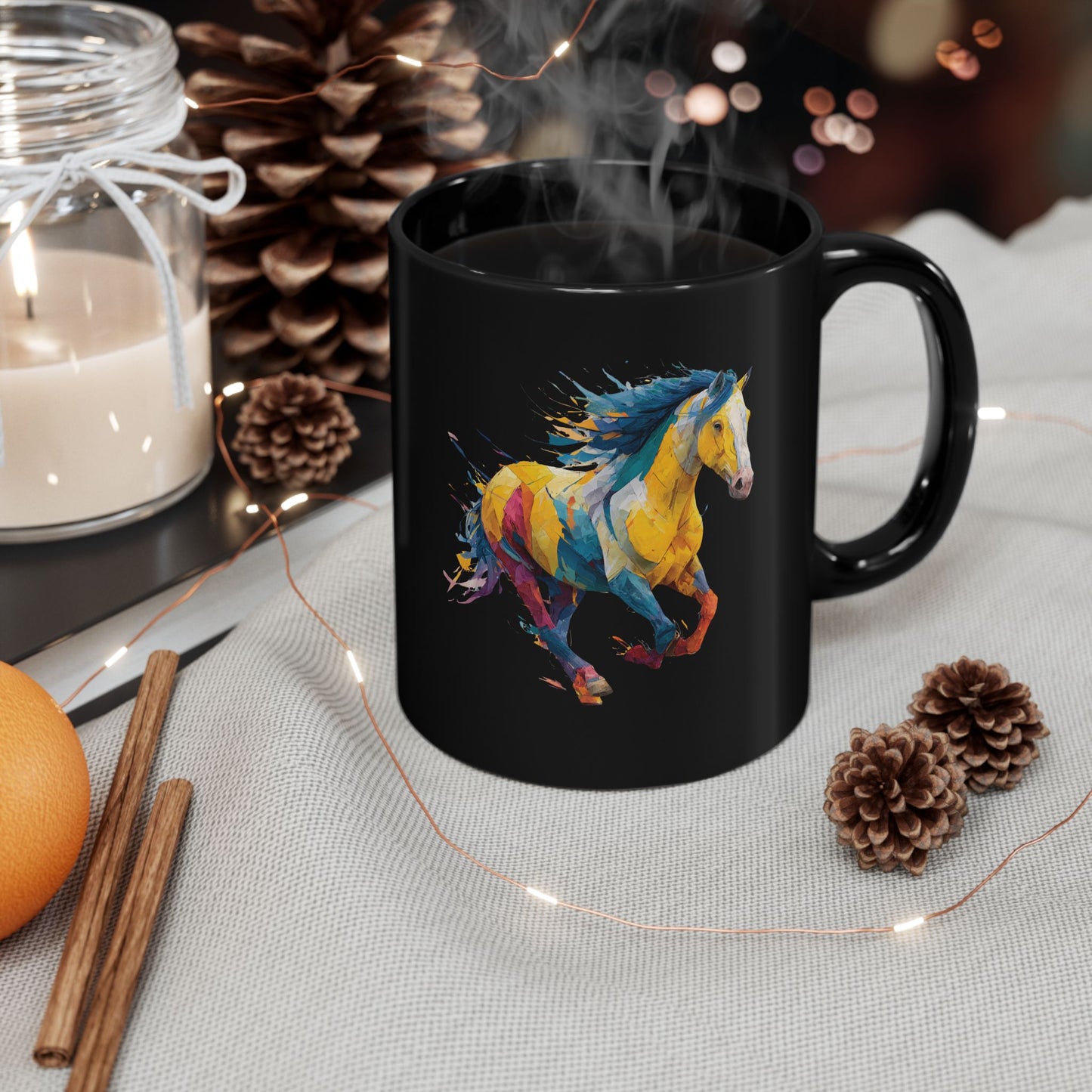 Black mug with a colorful horse design on a table with decorative items.