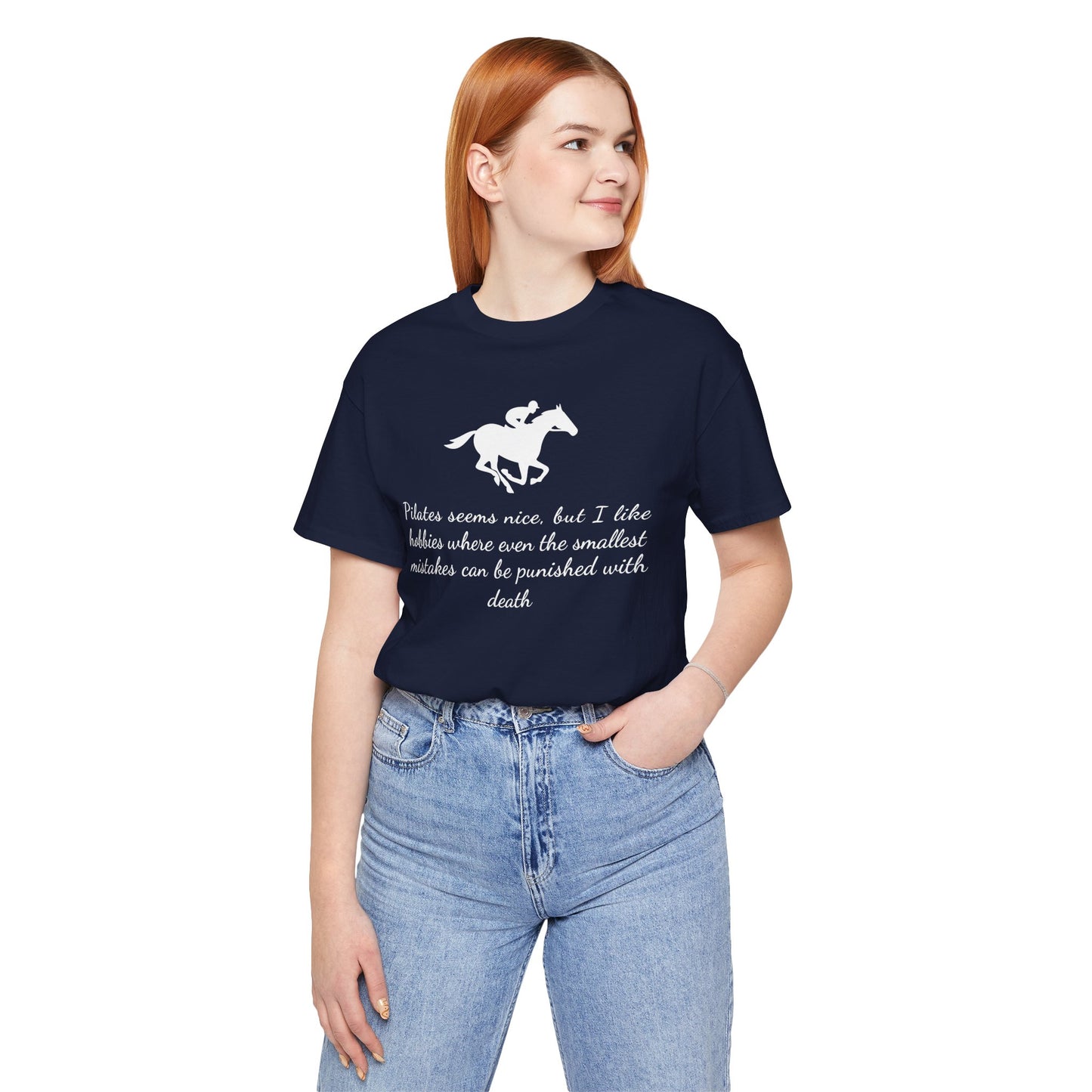 Person wearing a navy blue t-shirt with a horse graphic and text, standing against a white background