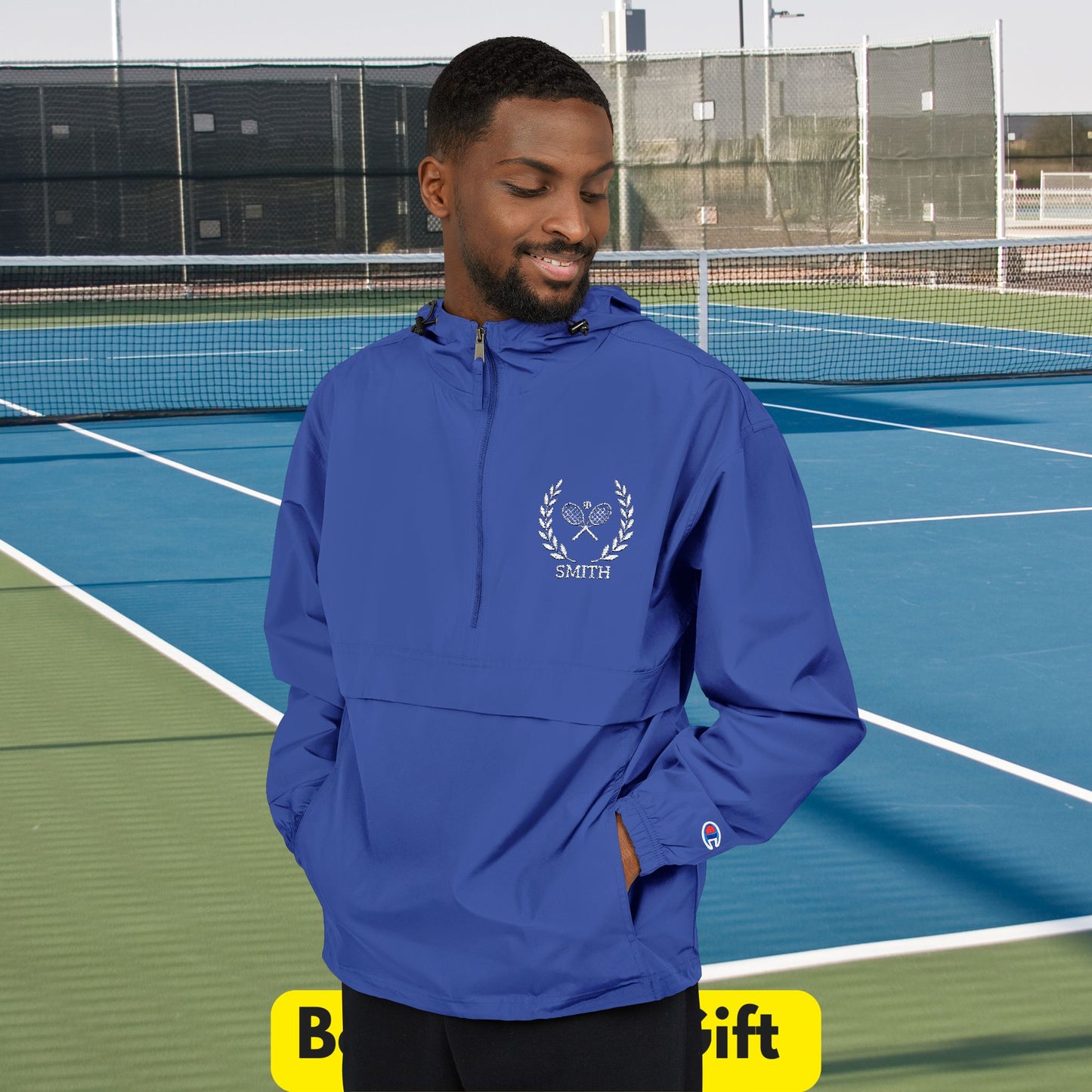 Tennis jacket Man wearing a blue jacket with a logo on a tennis court