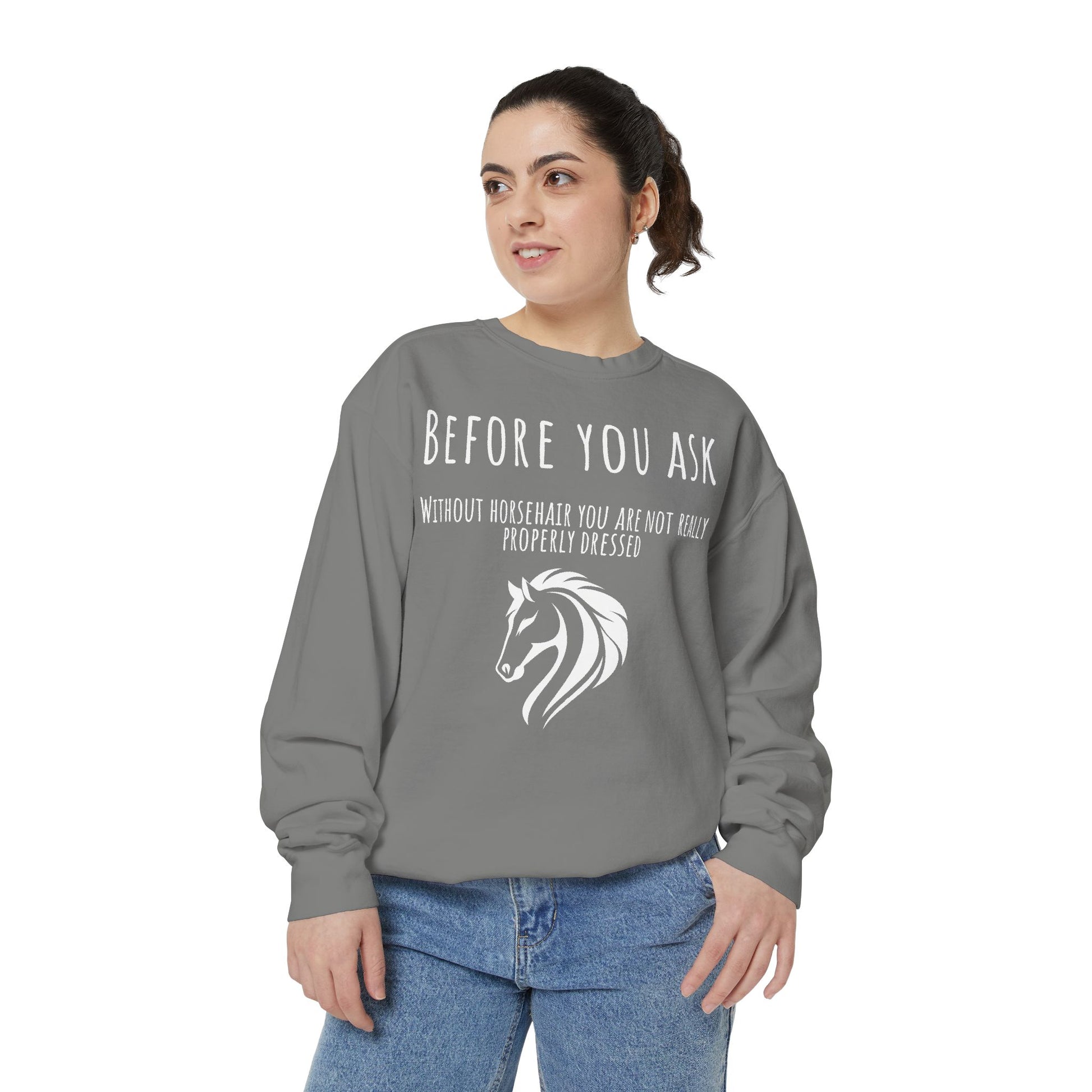 Woman wearing a gray sweatshirt with a horse graphic and text on a white background