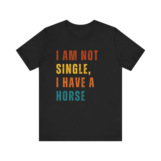 Black t-shirt with colorful text 'I AM NOT SINGLE, I HAVE A HORSE' on a white background