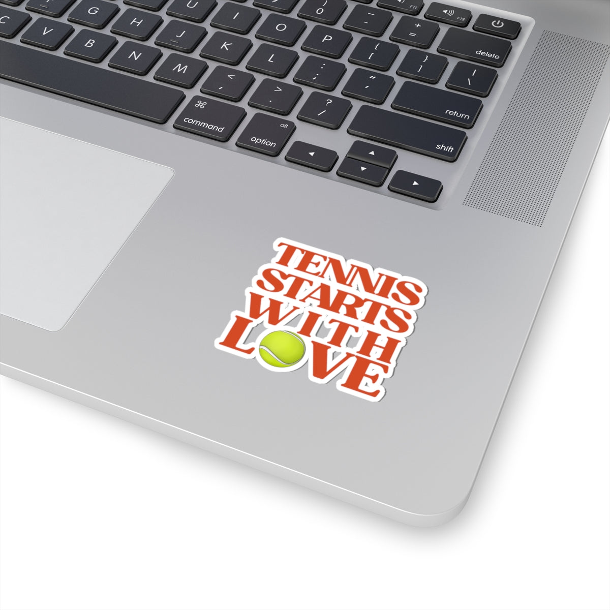 Laptop with a 'Tennis Starts with Love' sticker on the palm rest area