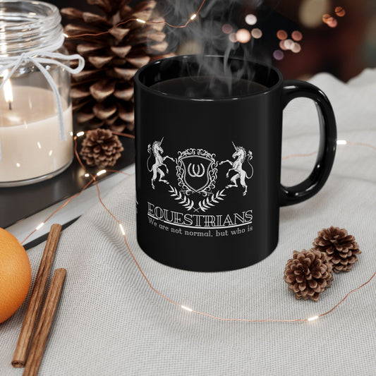 Black mug with 'Equestrians' design on a table with decorative items
