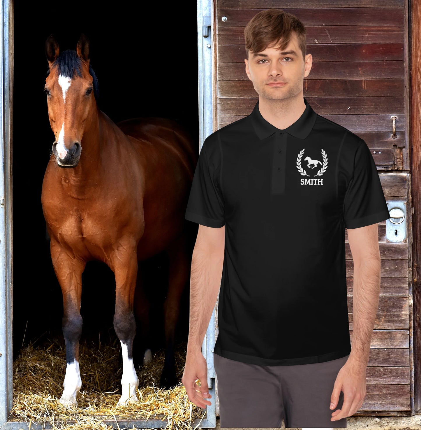 Equestrian polo shirt Man wearing a black polo shirt with a horse logo and 'Smith' text, standing next to a brown horse in a stable.