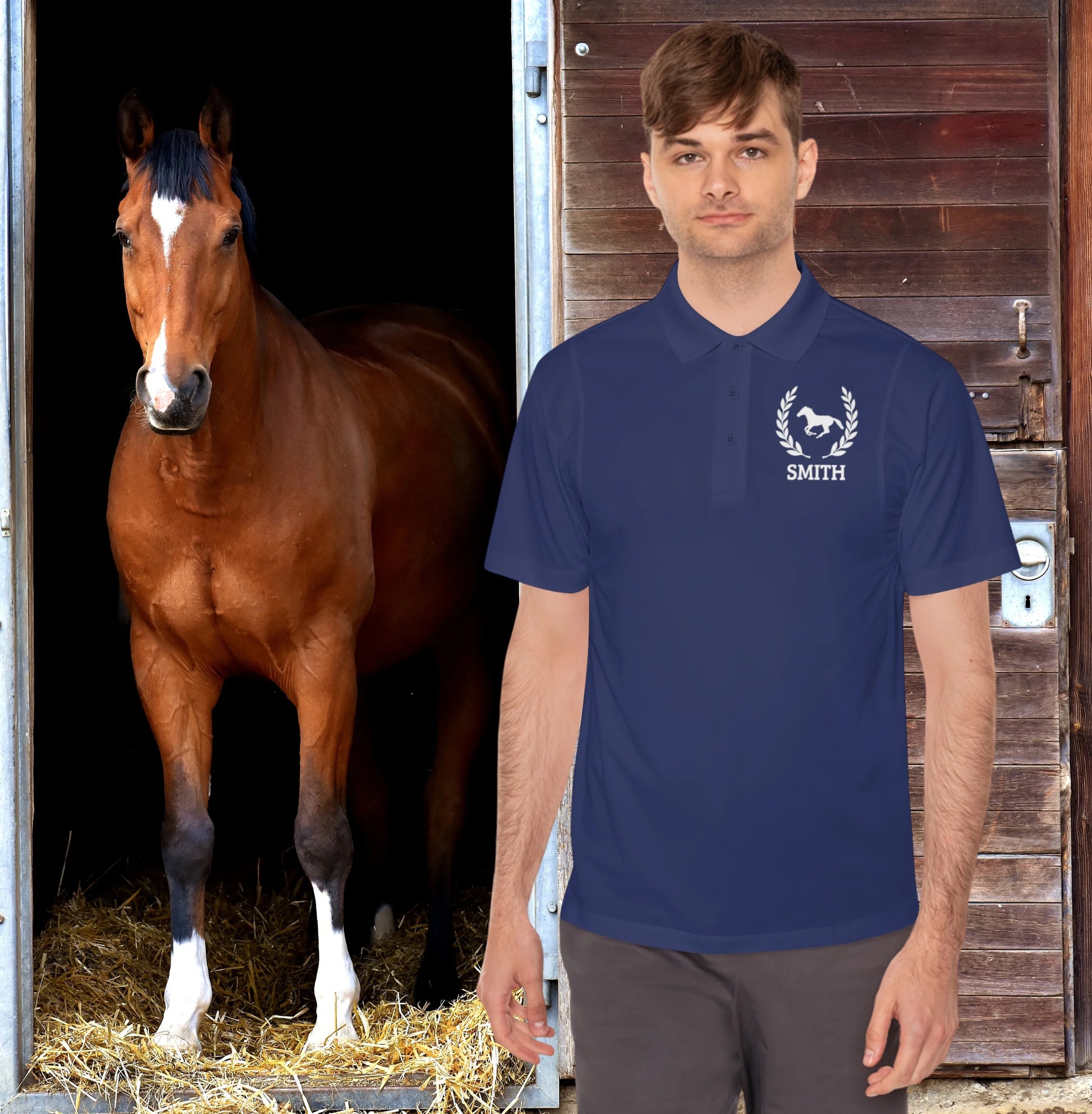 Equestrian polo shirt Man wearing a blue polo shirt with a horse logo and 'Smith' text, standing next to a brown horse in a stable.