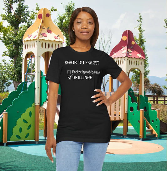 Gift for Triplets Person wearing a black t-shirt with text in front of a playground.