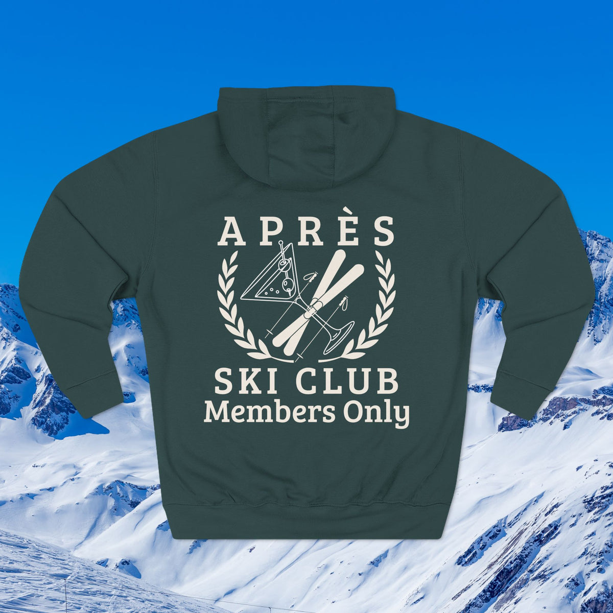 Its in my DNA A dark green hoodie shown from the back, featuring a white graphic print that reads 'APRÈS SKI CLUB Members Only' with crossed skis, poles, and a snowboard inside a laurel wreath. The hoodie is displayed against a scenic background of snowy mountains under a bright blue sky.