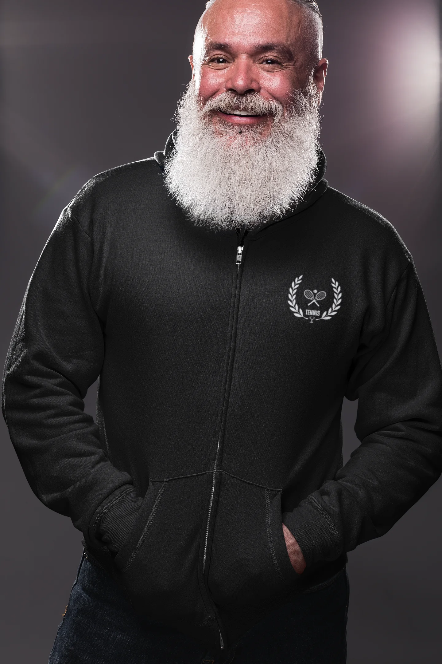 Man wearing a black hoodie with a logo on a dark background