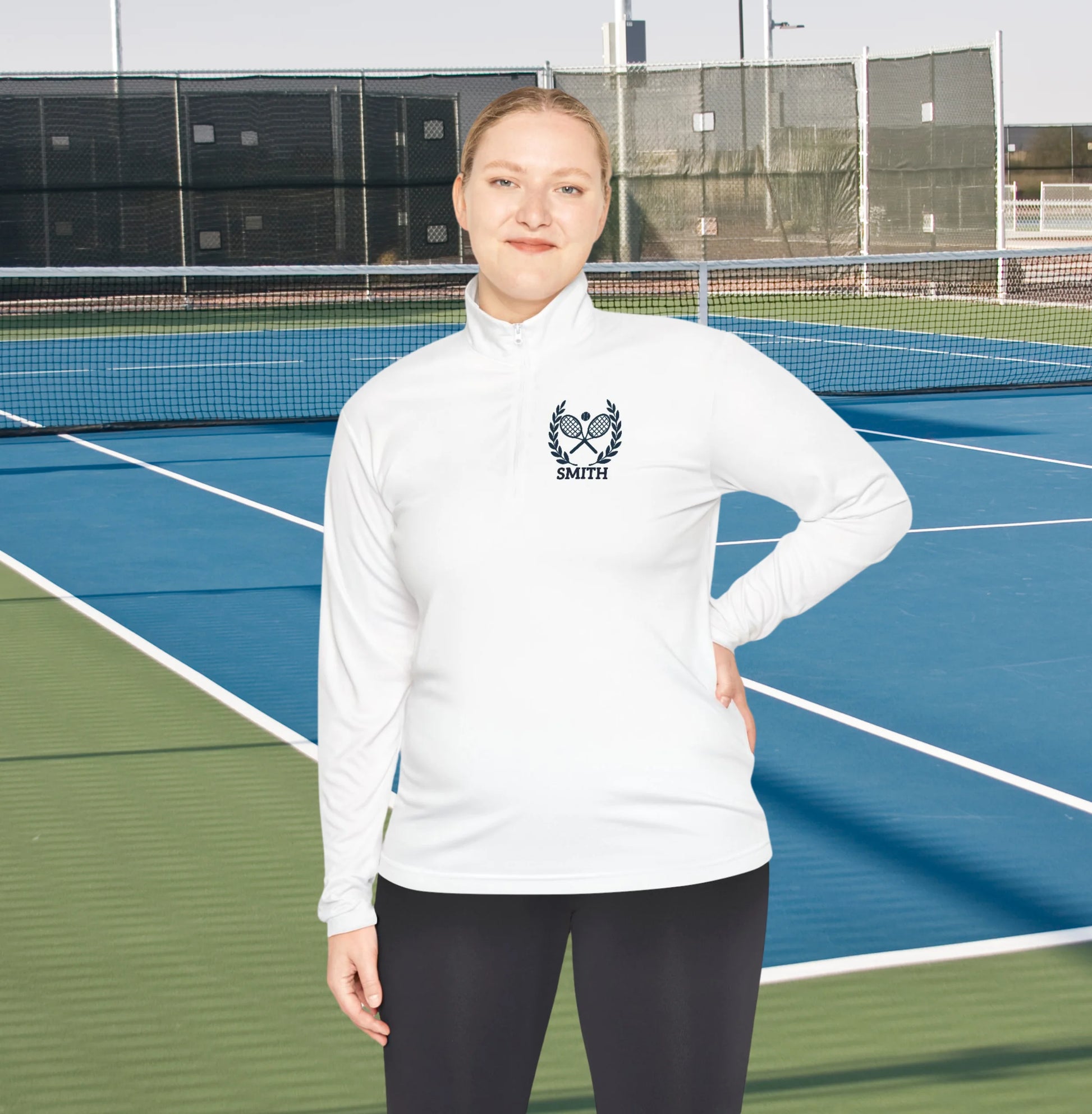 Personalized women tennis sweater Person wearing a white sweatshirt with a logo on a tennis court