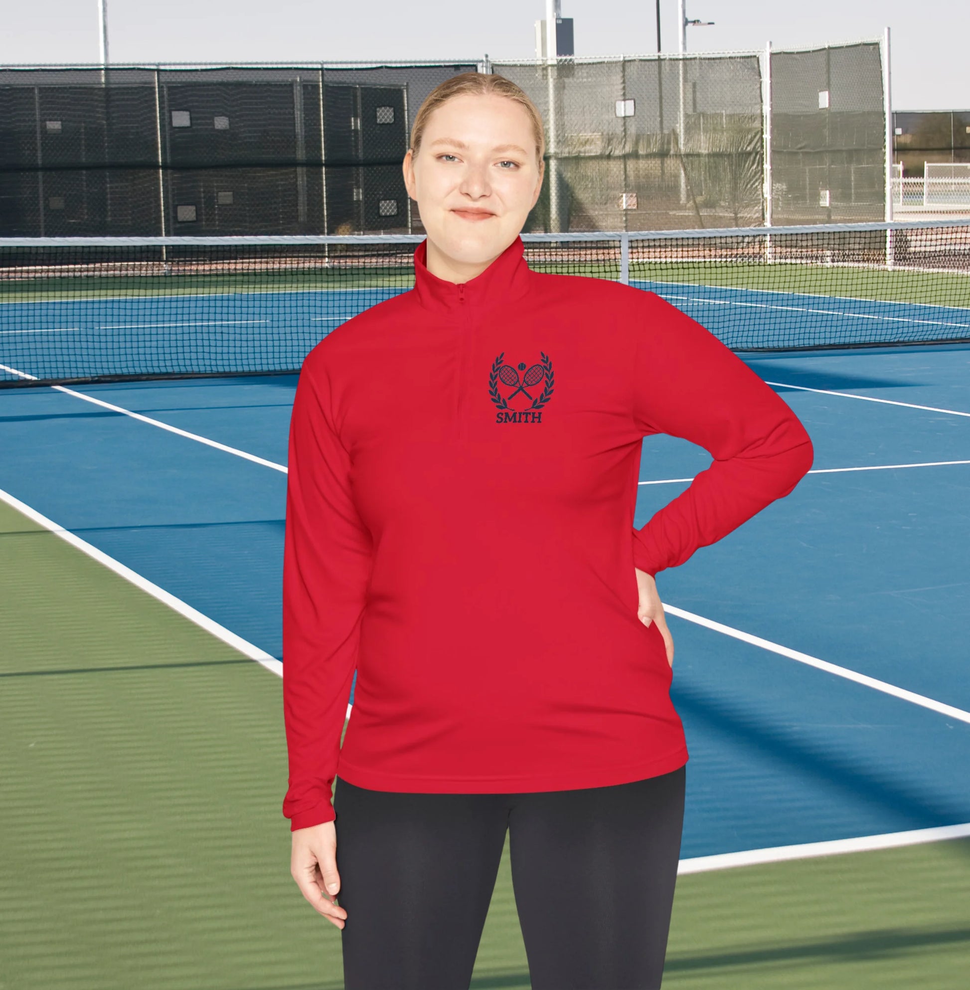 Personalized women tennis sweater Person wearing a red sweatshirt with a logo on a tennis court