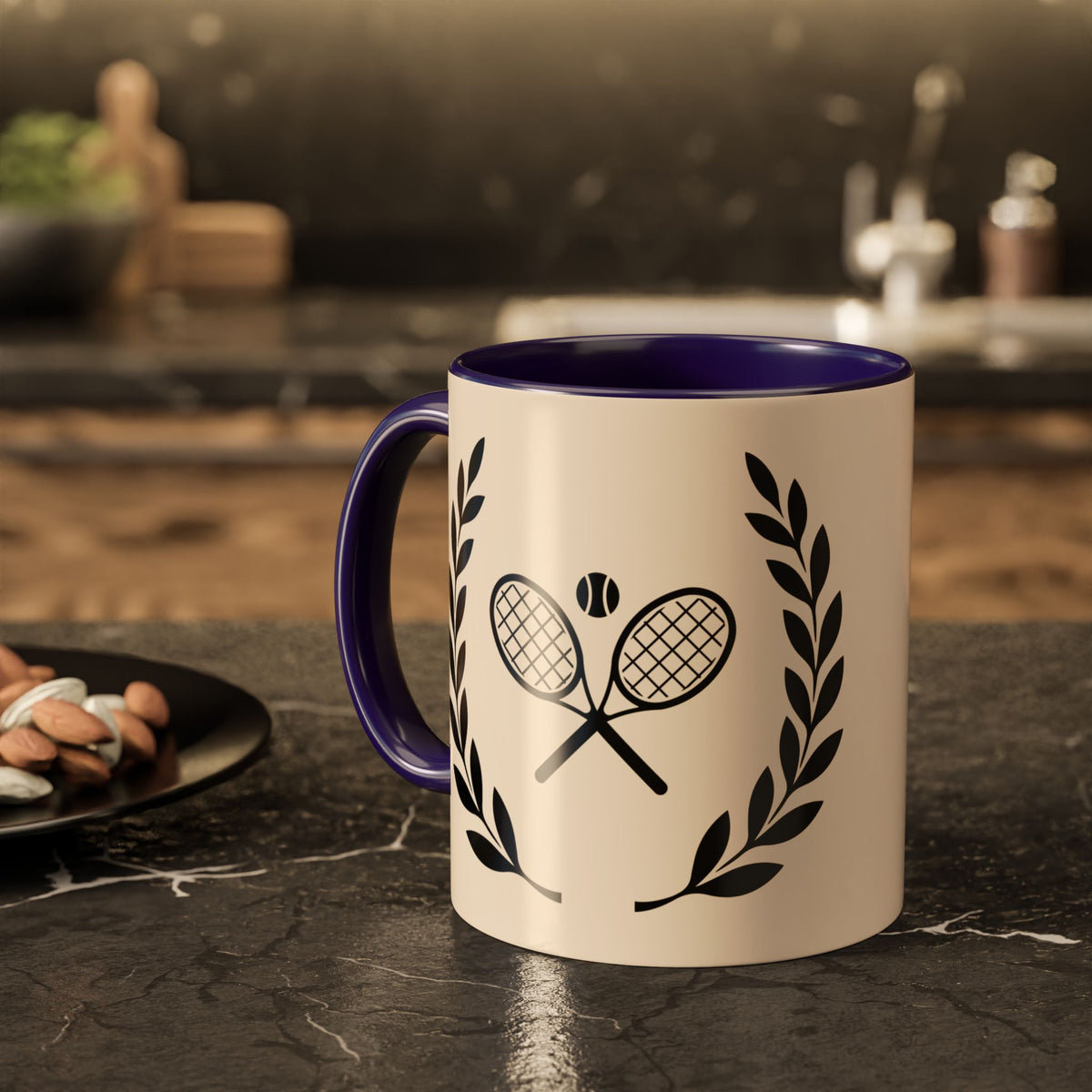 Tennis Coffee Mug A ceramic mug with a cream-colored exterior and a dark purple interior, featuring a black graphic of crossed tennis rackets and laurel leaves. The mug is set on a dark marble countertop in a kitchen environment.