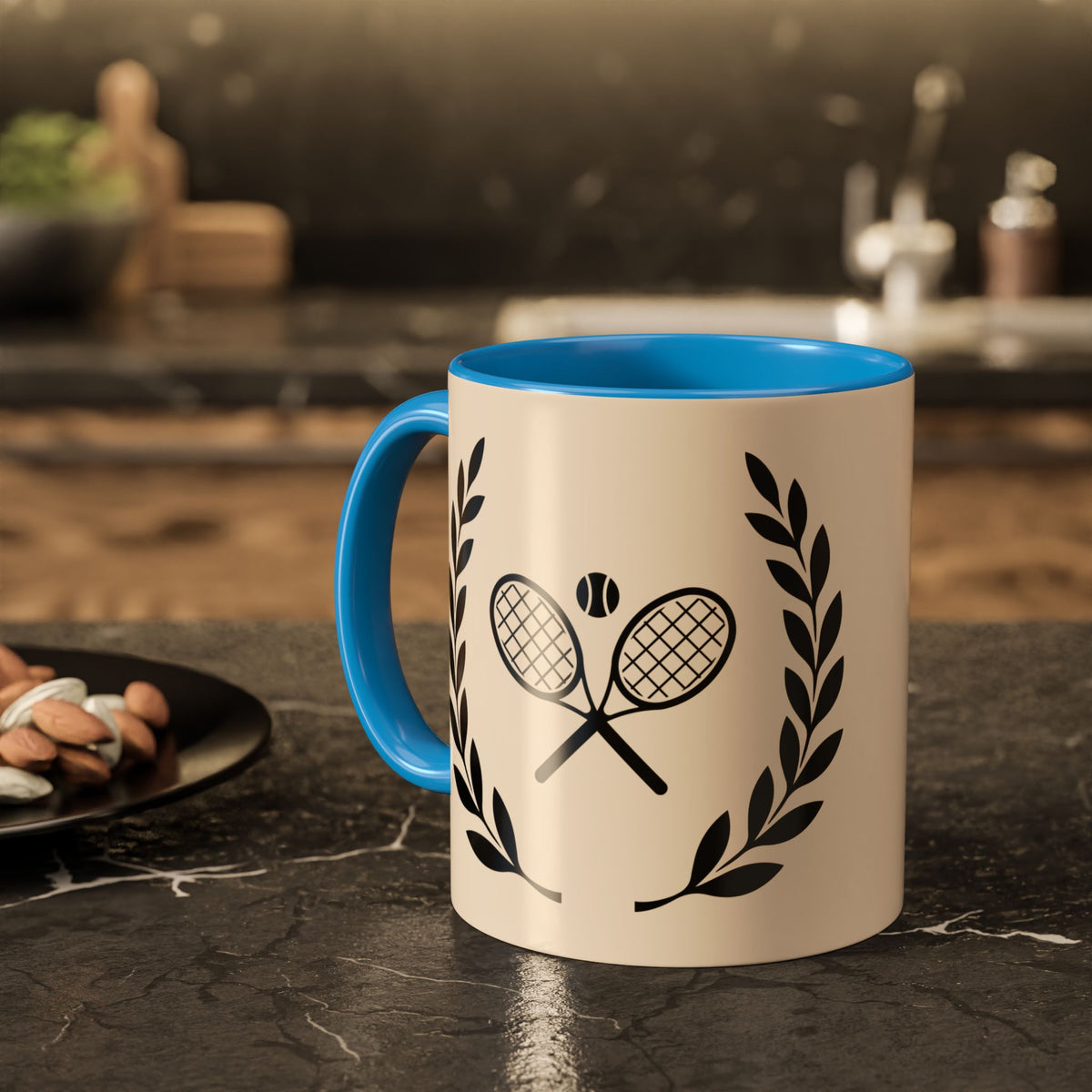 Tennis Coffee Mug A ceramic mug with a cream-colored exterior and a bright blue interior, handle, and rim. The mug features a black graphic of two crossed tennis rackets with a tennis ball in the center, flanked by laurel wreaths.