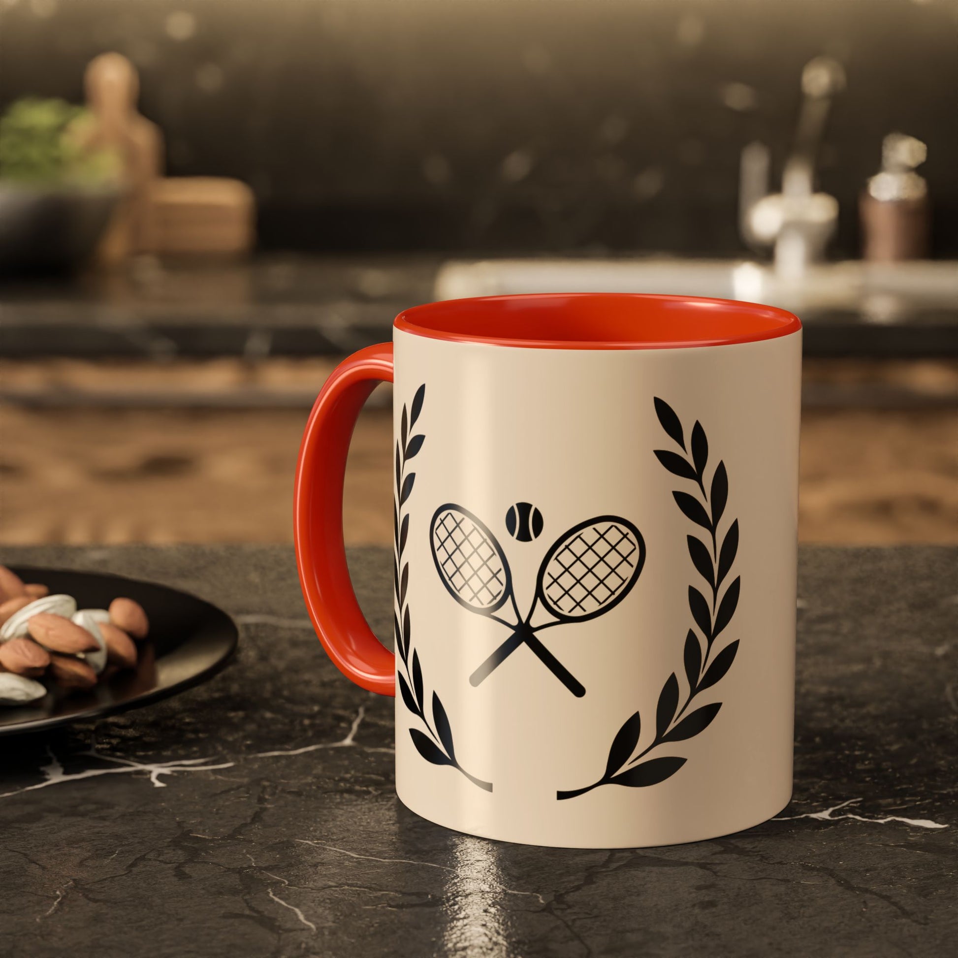 Tennis Coffee Mug A ceramic mug with a cream-colored exterior, a bright red interior and handle, and a black graphic of crossed tennis rackets with a tennis ball and laurel wreaths, set on a dark kitchen countertop.